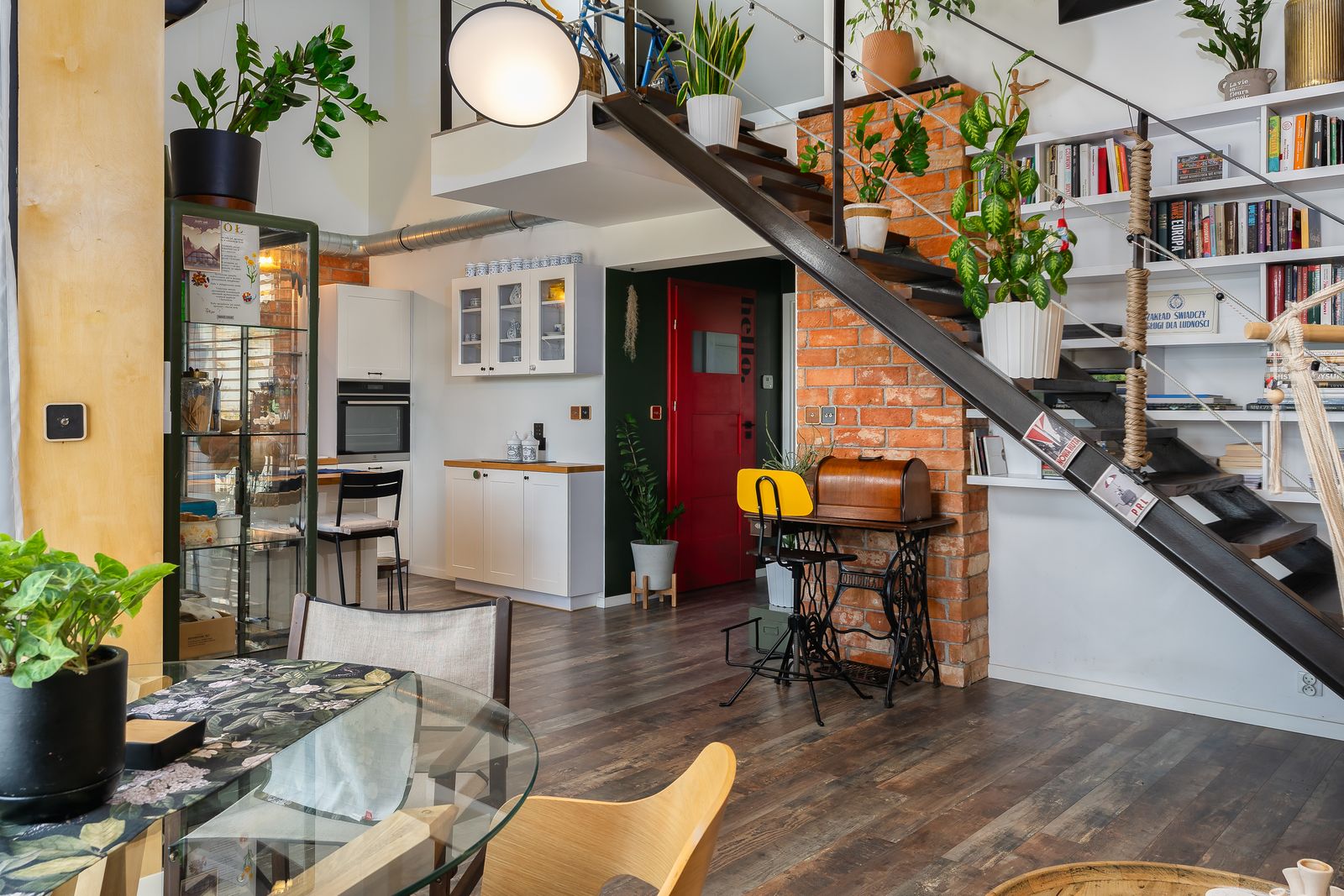 Colourful loft interior with plants and brick details